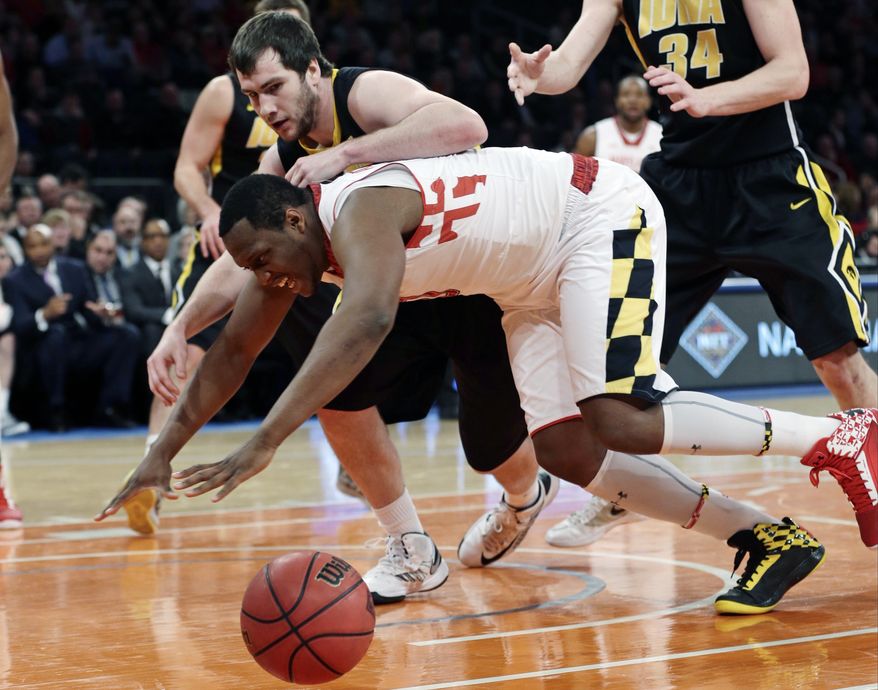Iowa's Zach McCabe (15) and Maryland's Charles Mitchell (0) fight for control of the ball during the first half of an NIT semifinal basketball game Tuesday, April 2, 2013, in New York. (AP Photo/Frank Franklin)
