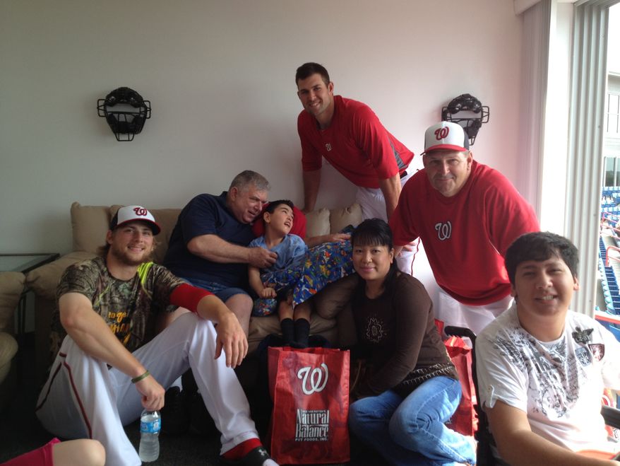 Nationals pitchers Ross Detwiler, left, Craig Stammen, top right, and third base coach Trent Jewett, right, visit with children and parents from Wheelchairs 4 Kids before a spring training game in Viera, Fla. (Photo courtesy of Wheelchairs 4 Kids)