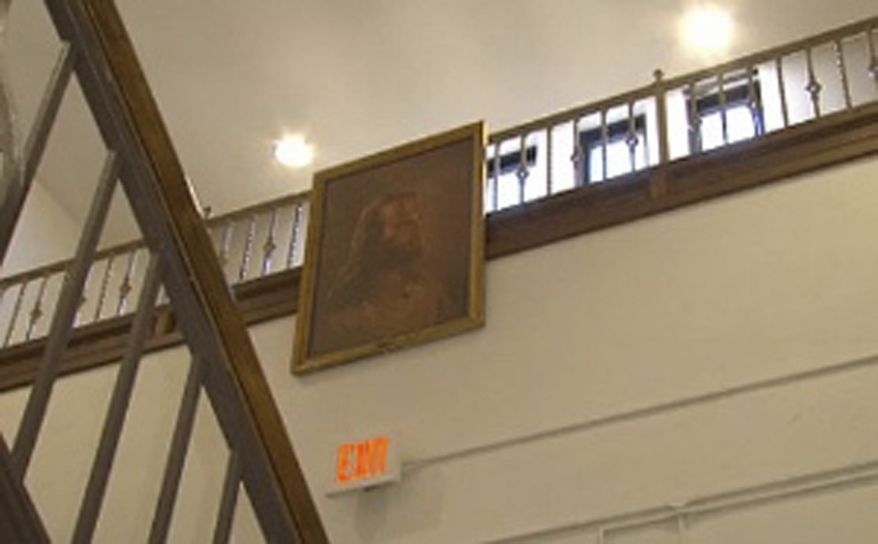 ** FILE ** In this Thursday, Feb. 7, 2013, photo, a portrait of Jesus hangs in the hallway at Jackson Middle School in Jackson, Ohio. The superintendent of the southern Ohio district facing a federal lawsuit over the Jesus portrait says it's been moved to a high school at the preference of the Christian-based student club that the district views as the picture's owner. (AP Photo/WBNS-10 TV)