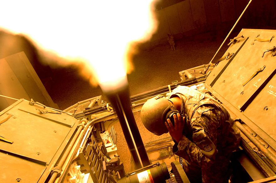 Gunner SPC David Johnson and Assistant Gunner SGT Justin Javar from HHC 1/17th Battalion Mortars 172nd SBCT Ft. Wainwright, AK fire illumination flares over the city of Mosul, Iraq with a 120mm Mortar Cannon June 1, 2006 from a Mortar Carrier Stryker (an eight wheeled medium armored weapons combat troop transport vehicle). The illumination flares being fired will brighten the city in hopes it will help deny the terrorist terrain so they are less likely to place IED's. (U.S. Air Force photo by TSgt Jeremy T. Lock)