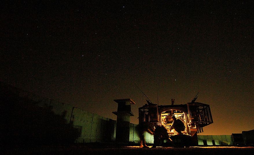 U.S. Army Soldiers try to pull an illumination flare from it's case before firing it over the city of Mosul, Iraq, June 1, 2006, with a 120mm mortar cannon. The illumination flares are fired will brighten the city to deter terrorist from planting improvised explosive devices. The Soldiers are from Headquarters and Headquarters Company, 1st Battalion, 17th Battalion Mortars, 172nd Stryker Brigade Combat Team. (U.S. Air Force photo by Tech. Sgt. Jeremy T. Lock)