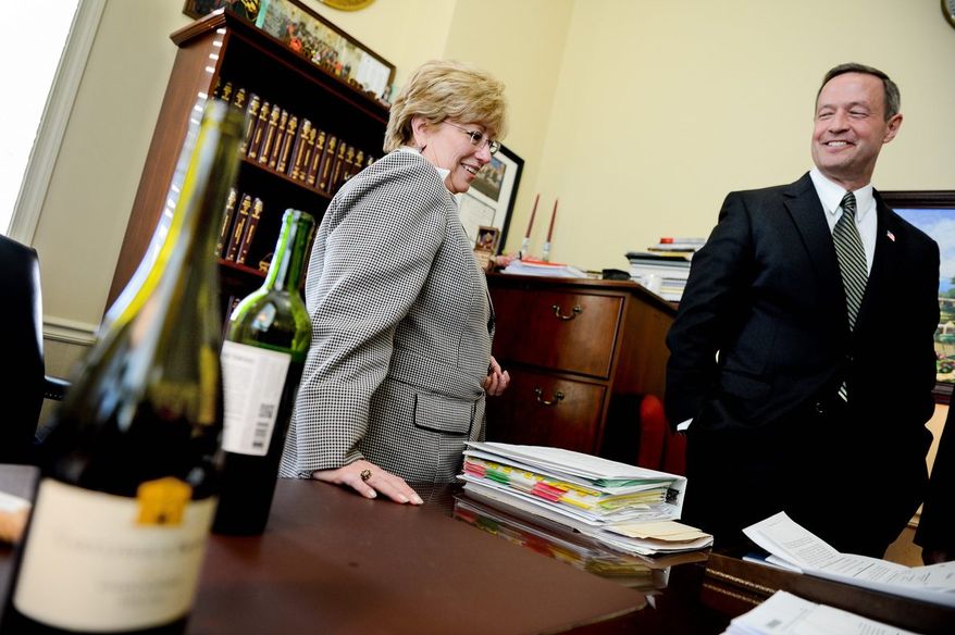 Gov. Martin O'Malley, a strong supporter of the legislation, congratulates Delegate Kathleen M. Dumais, Montgomery Democrat. (Andrew Harnik/The Washington Times)