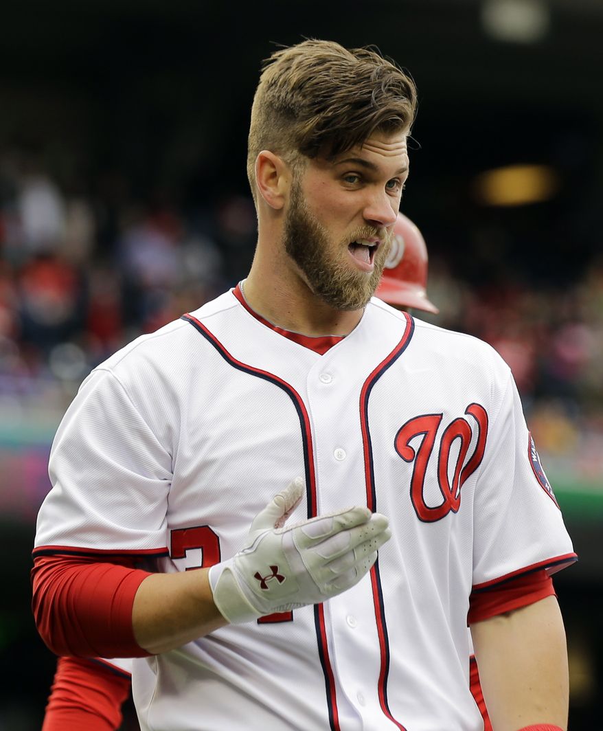 Washington Nationals' Bryce Harper reacts after sliding safely into home during the first inning of a baseball game against the Miami Marlins at Nationals Park, Thursday, April 4, 2013, in Washington. (AP Photo/Alex Brandon)