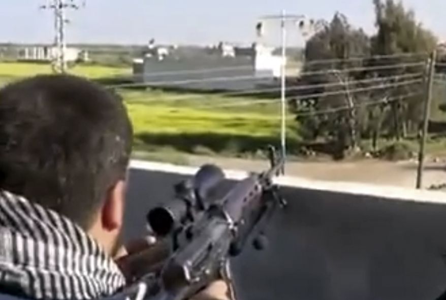 ** FILE ** Fighters from the Syrian Free Army fire on a Syrian army position in Deal, Syria, less than 10 miles from the Jordanian border in Daraa province, on Thursday, March 28, 2013, in an image taken from video that was authenticated based on its contents and other AP reporting. (AP Photo/Ugarit News via AP video)