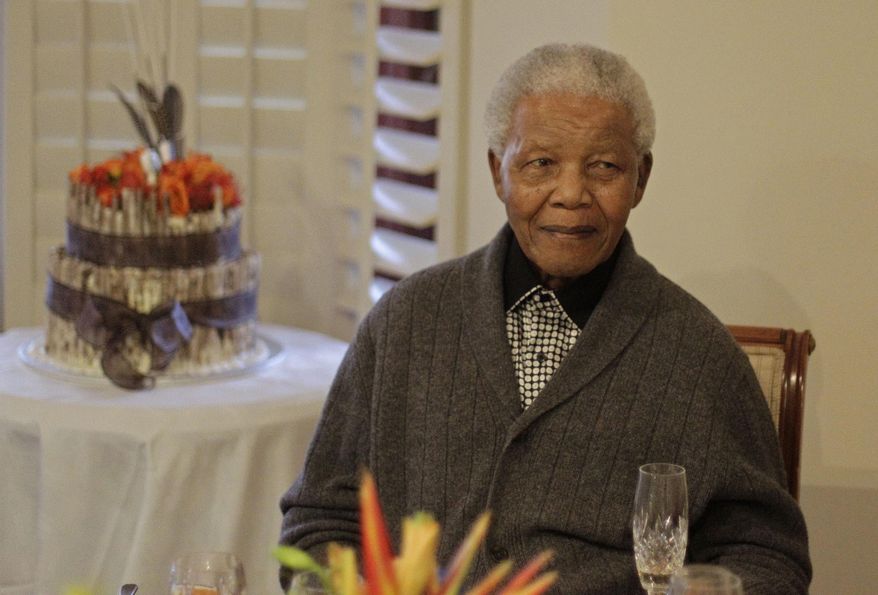 ** FILE ** Former South African President Nelson Mandela as he celebrates his 94th birthday with family in Qunu, South Africa, on July 18, 2012. Mr. Mandela just celebrated his 95th birthday on July 18, 2013, while recovering from a lung infection. (Associated Press)