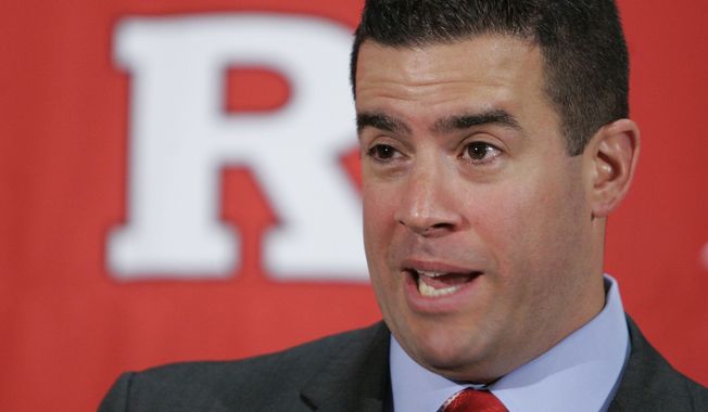 ** FILE ** In this Feb. 26, 2009, file photo, Tim Pernetti speaks to reporters after he was named the new athletic director at Rutgers University during a news conference on the university campus in Newark, N.J. A person familiar with the decision says Pernetti is out as Rutgers athletic director. (AP Photo/Mike Derer, File)