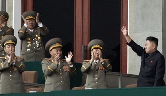 **FILE** North Korean leader Kim Jong-un (left) waves April 14, 2012, as North Korean military officers clap at a stadium in Pyongyang during a mass meeting called by the Central Committee of North Korea&#39;s ruling party. (Associated Press)