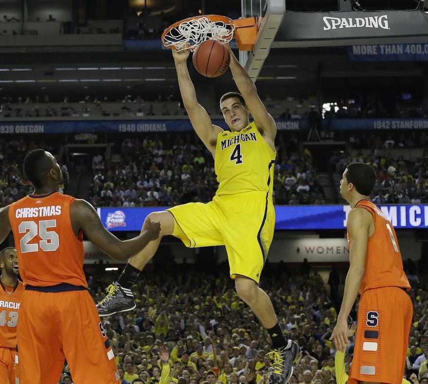 Michigan's Mitch McGary dunks the ball against Syracuse during the second half of the NCAA Final Four tournament college basketball semifinal game Saturday, April 6, 2013, in Atlanta. (AP Photo/Charlie Neibergall)