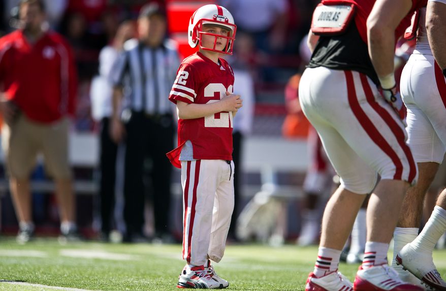 Jack Hoffman takes the field with the Husker football team in the fourth quarter Nebraska's spring NCAA college football game at Memorial Stadium in Lincoln, Neb., on Saturday, April 6, 2013. Hoffman, for whom Team Jack is named, suffers from pediatric brain cancer. (AP Photo/The Omaha World-Herald/Ryan Soderlin)