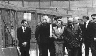 **FILE** Britain&#39;s Prime Minister Margaret Thatcher, surrounded by officials, visits the Sheffield football stadium in Sheffield, England on April 16, 1989, where yesterday, 108 supporters were killed in a crush, at the start of a cup semi-final. (AP Photo)