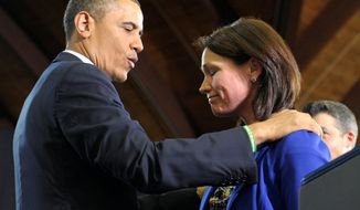President Obama comforts Nicole Hockley on Monday at the University of Hartford in Connecticut. Mrs. Hockley and her husband, Ian, lost their son, Dylan, in the Sandy Hook Elementary School shooting in December. Mr. Obama is pushing Congress to hold votes on the gun controls he has proposed. (Associated Press)
