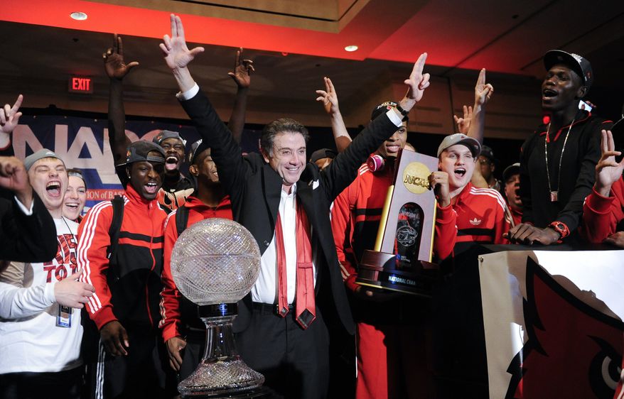 Louisville coach Rick Pitino and team celebrate at the trophy ceremony after winning the NCAA Final Four tournament college basketball championship game against Michigan, Monday, April 8, 2013, in Atlanta. Louisville won 82-76. (AP Photo/John Amis)