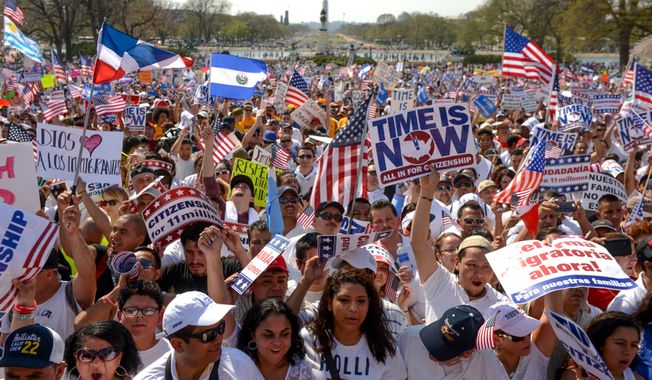 **FILE** Hundreds of people attend the National Rally for Citizenship on the west lawn of the U.S. Capitol in Washington on April 10, 2013, to call for immigration reform. (Andrew Harnik/The Washington Times)