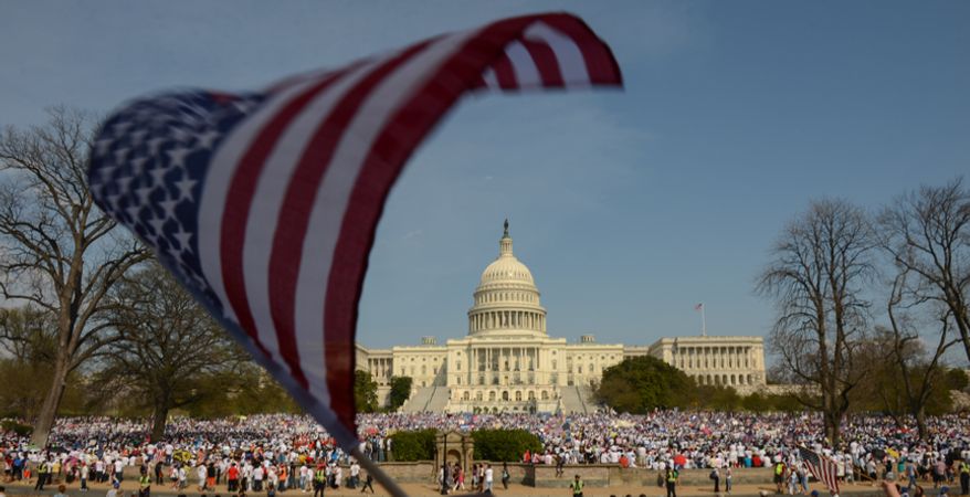 **FILE** Hundreds of people attend the National Rally for Citizenship on the west lawn of the U.S. Capitol in Washington on April 10, 2013, to call for immigration reform. (Andrew Harnik/The Washington Times)