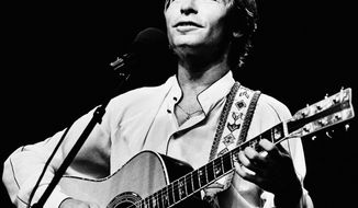 Singer John Denver performs during an outdoor concert in Boston in 1983. (AP Photo/Keith Jacobson)