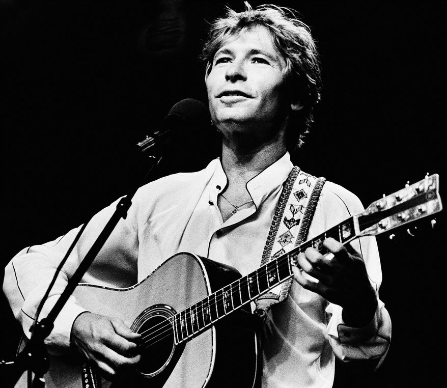 Singer John Denver performs during an outdoor concert in Boston in 1983. (AP Photo/Keith Jacobson)