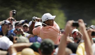 Tiger Woods tees off on the first hole during a practice round for the Masters golf tournament Tuesday, April 9, 2013, in Augusta, Ga. (AP Photo/Charlie Riedel)