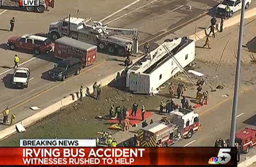 This frame grab provided by KXAS-TV shows emergency personnel at the scene where a chartered bus overturned on a highway near Dallas-Fort Worth International Airport in Irving, Texas. (AP Photo/KXAS-TV)