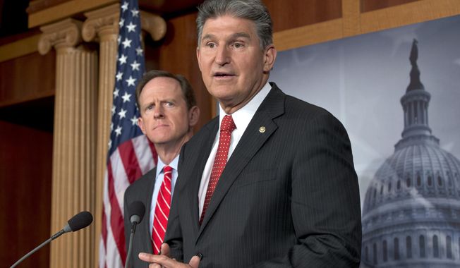 ** FILE ** Sen. Joe Manchin III (right), West Virginia Democrat, accompanied by Sen. Patrick J. Toomey, Pennsylvania Republican, announces on Wednesday, April 10, 2013, on Capitol Hill in Washington that they have reached a bipartisan deal on expanding background checks to more gun buyers. (AP Photo/J. Scott Applewhite)