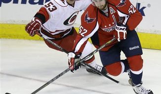 Carolina Hurricanes center Jeff Skinner (53) chases after Washington Capitals defenseman Mike Green (52) during the first period of an NHL hockey game on Thursday, April 11, 2013, in Washington. (AP Photo/Evan Vucci)