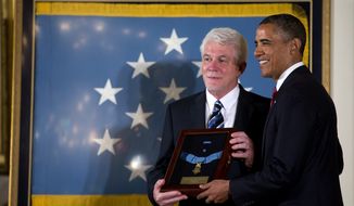 President Barack Obama stands with Ray Kapaun, nephew of Chaplain (Captain) Emil J. Kapaun, U.S. Army, as he awards the Medal of Honor posthumously to Chaplain Kapaun in the East Room of the White House in Washington on April 11, 2013. (Associated Press)
