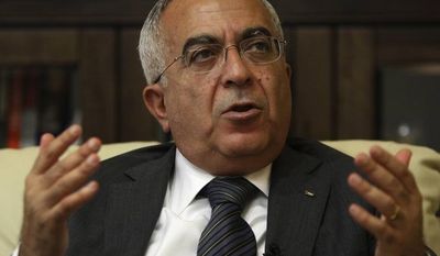 ** FILE ** In this June 28, 2011, file photo, Palestinian Prime Minister Salam Fayyad speaks during an interview with The Associated Press in the West Bank city of Ramallah. Palestinian officials said Thursday, April 11, 2013, that Fayyad offered his resignation to President Mahmoud Abbas as part of an increasingly bitter conflict over authority. (AP Photo/Majdi Mohammed, File)