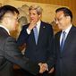 U.S. Secretary of State John Kerry, center, looks on as U.S. Ambassador to China Gary Locke, left, shakes hands with China&#39;s Premier Li Keqiang during a meeting at the Zhongnanhai compound in Beijing Saturday, April 13, 2013. (Associated Press)