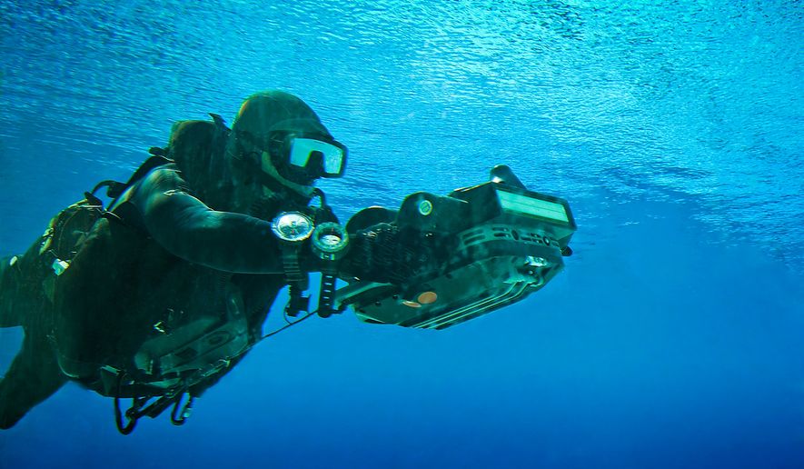 A U.S. Navy SEAL using a computerized  HMU underwater to take measurements of a beach landing area. Photo: (C) 2011 Greg E. Mathieson Sr. / NSW Publications, LLC