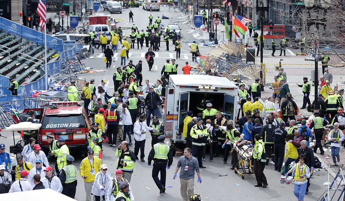 Medical workers aid injured people at the finish line of the 2013 Boston Marathon following an explosion in Boston, Monday, April 15, 2013. (AP Photo/Charles Krupa)