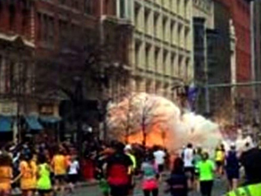 ** FILE ** In this image from video provided by WBZ TV, spectators and runners run from what was described as twin explosions that shook the finish line of the Boston Marathon, Monday, April 15, 2013, in Boston. Two explosions shattered the euphoria of the Boston Marathon finish line on Monday, sending authorities out on the course to carry off the injured while the stragglers were rerouted away from the smoking site of the blasts. (AP Photo/WBZTV)