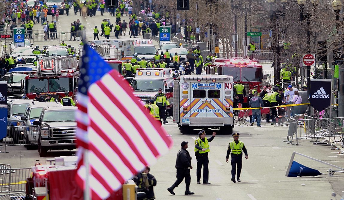 Emergency workers aid injured people at the finish line of the 2013 Boston Marathon following an explosion in Boston, Monday, April 15, 2013. (AP Photo/Charles Krupa)