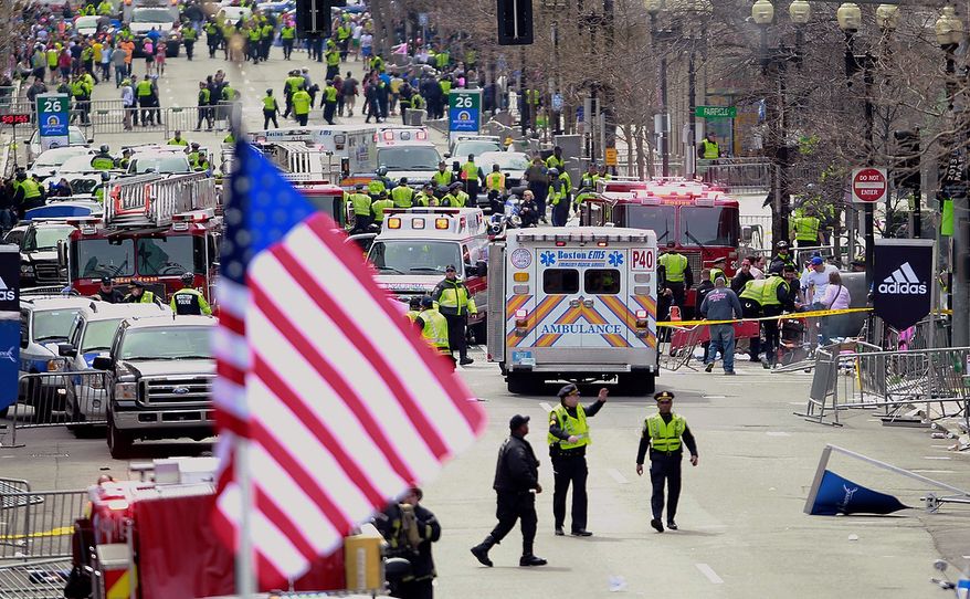 Emergency workers aid injured people at the finish line of the 2013 Boston Marathon following an explosion in Boston, Monday, April 15, 2013. (AP Photo/Charles Krupa)