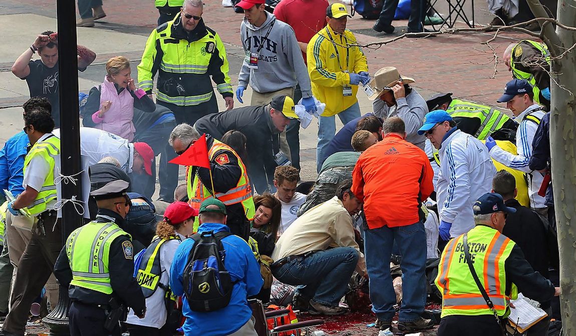 Medical workers aid injured people at the 2013 Boston Marathon following an explosion in Boston on Monday, April 15, 2013. Two explosions shattered the euphoria at the marathon&#x27;s finish line on Monday, sending authorities out on the course to carry off the injured while the stragglers were rerouted away from the smoking site of the blasts. (AP Photo/The Boston Globe, David L Ryan) ** FILE **