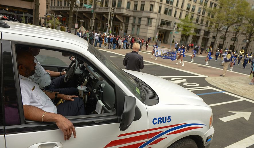 Washington Metropolitan Police Officers keep watch along Pennsylvania Ave. during the Washington, D.C. Emancipation Day parade, Washington, D.C., Tuesday, April 16, 2013. President Abraham Lincoln freed approximately 3,100 slaves in the District of Colombia on April 16, 1862, nine months before the Emancipation Proclamation. (Andrew Harnik/The Washington Times)