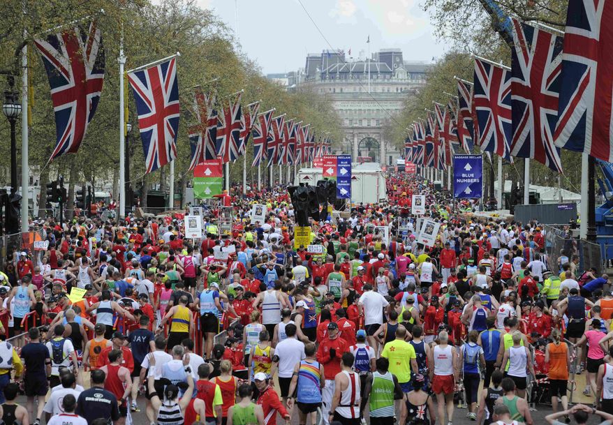 FILE - In this April 25, 2010 file photo, competitors make their way from the finish area at the London Marathon. Determined to put on a show of "solidarity" for Boston, London Marathon organizers will stage the race on Sunday, April 21, 2013. The British capital has long been a top target for terrorists, and these concerns have only intensified after harrowing scenes from the Boston Marathon on Monday, April 15, 2013,where bombs killed three people and injured more than 170. (AP Photo/Tom Hevezi, File)