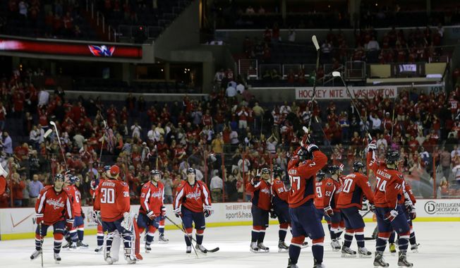 The Washington Capitals salute the fans after their win over the Toronto Maple Leafs in an NHL hockey game Tuesday, April 16, 2013 in Washington. The Capitals won 5-1. (AP Photo/Alex Brandon)