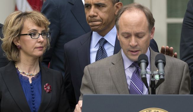 ** FILE ** President Obama arrives to participate in a news conference in the Rose Garden of the White House on April 17, 2013, about measures to reduce gun violence. With Obama is former Rep. Gabby Giffords (left) and Mark Barden, the father of Newtown shooting victim Daniel. (Associated Press)