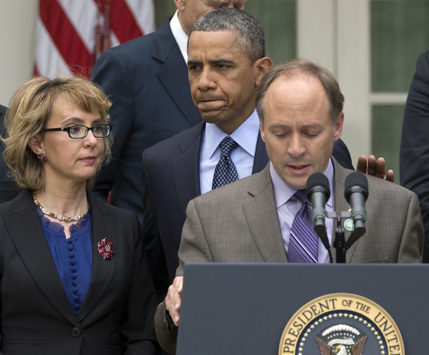 ** FILE ** President Obama arrives to participate in a news conference in the Rose Garden of the White House on April 17, 2013, about measures to reduce gun violence. With Obama is former Rep. Gabby Giffords (left) and Mark Barden, the father of Newtown shooting victim Daniel. (Associated Press)