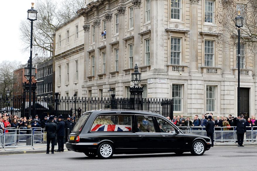 A hearse transporting the coffin containing the body of former British Prime Minister Margaret Thatcher makes its way past Downing Street in London, England, Wednesday, April 17, 2013. (AP Photo/Gareth Cattermole, Pool)