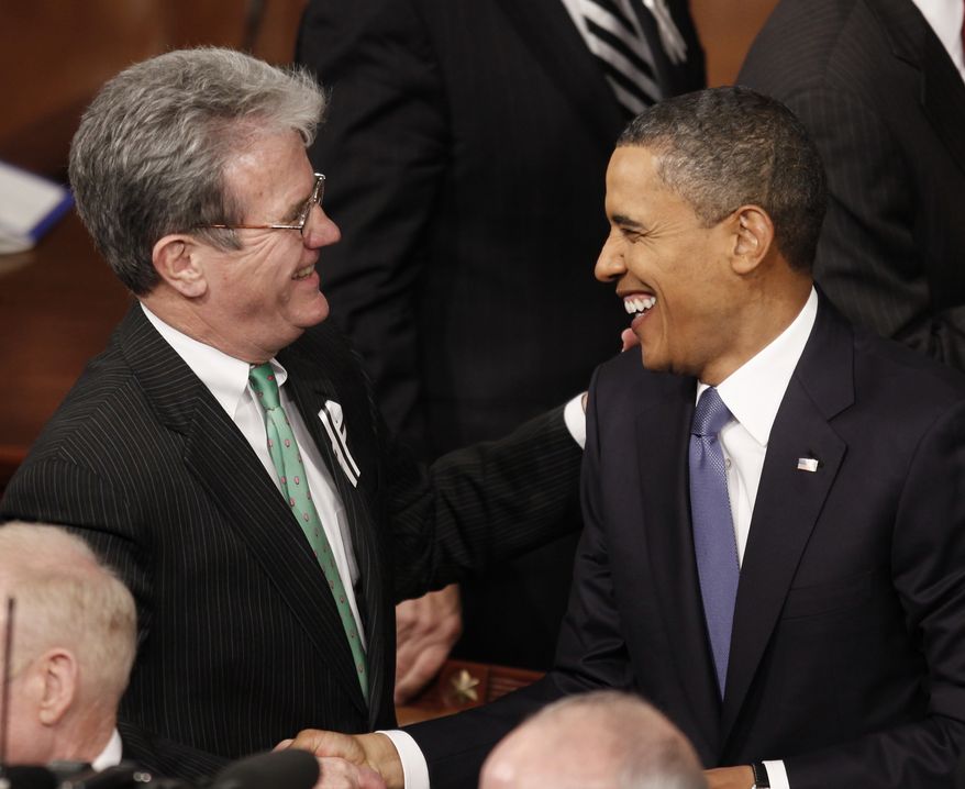 **FILE** President Obama greets Sen. Tom Coburn, Oklahoma Republican, on Capitol Hill in Washington on Jan. 25, 2011, before the president delivered his State of the Union address. (Associated Press)