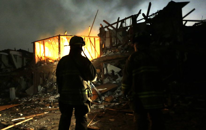 Firefighters use flashlights to search a destroyed apartment complex near a fertilizer plant that exploded earlier in West, Texas, in this photo taken early on Thursday, April 18, 2013. (AP Photo/LM Otero)