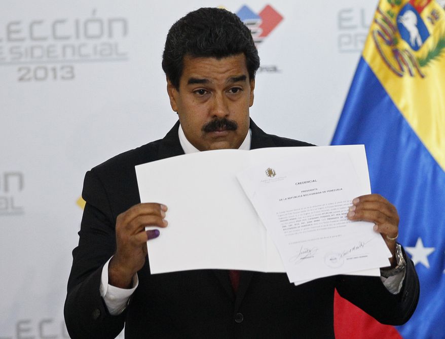 ** FILE ** Venezuelan Interim President Nicolas Maduro holds the official certificate declaring him the winner of the presidential election, at the Electoral Council in Caracas, Venezuela, on Monday, April 15, 2013. The nation's government-friendly Electoral Council quickly certified the razor-thin presidential victory of the late President Hugo Chavez's hand-picked successor over challenger Henrique Capriles. (Associated Press)