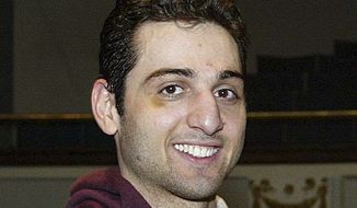 **FILE** Tamerlan Tsarnaev smiles after accepting the trophy for winning the 2010 New England Golden Gloves Championship in Lowell, Mass., on Feb. 17, 2010. The 26-year-old boxer, who had been known to the FBI as Suspect No. 1 in the Boston Marathon explosions and was seen in surveillance footage in a black baseball cap, was killed on April 19, 2013, officials said. (Associated Press/The Lowell Sun)