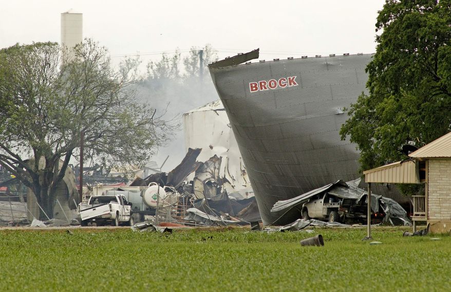 Mangled metal and crushed vehicles are all that remains at the blast site of the fertilizer company, Thursday, April 18, 2013, in West Texas. (AP Photo/The Fort Worth Star-Telegram, Paul Moseley)