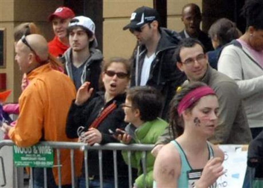 ** FILE ** Runner Bob Leonard captured pictures of the Boston Marathon bombing suspects on April 15, 2013, in Boston. Tamerlan Tsarnaev (third from left), who was dubbed Suspect No. 1, and his brother, Dzhokhar Tsarnaev, who was dubbed Suspect No. 2 by law enforcement, are pictured approximately 10 to 20 minutes before the blasts. (AP Photo/Bob Leonard)