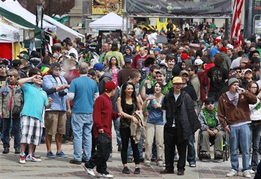Crowds begin to gather at the Denver 4/20 pro-marijuana rally at Civic Center Park in Denver on Saturday, April 20, 2013. Authorities generally look the other way at public pot smoking here on April 20. (AP Photo/Brennan Linsley)