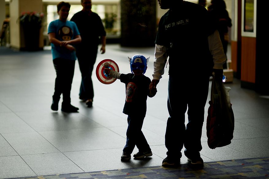 Eligah McNutt, 4, of South Riding, Va., center, dresses as Captain America at Awesome Con D.C., a comic book convention at the Washington Convention Center, Washington, D.C., Sunday, April 21, 2013. (Andrew Harnik/The Washington Times)