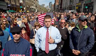 A moment of silence in honor of the victims of the Boston Marathon bombing is observed at 2:50 p.m. Monday on Boylston Street near the race finish line, exactly one week after the tragedy. (Associated Press)