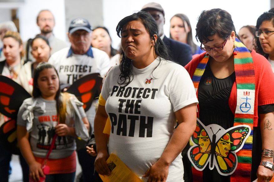 Kristina Tendilla (center) of Chicago gets emotional as she tells her family's story amid pro-immigration supporters from National People's Action group as they gather outside the doors to the Senate Judiciary Committee before a hearing on immigration on Capitol Hill on April 22, 2013. Immigration supporters are using the monarch butterfly to symbolize free migration. (Andrew Harnik/The Washington Times)