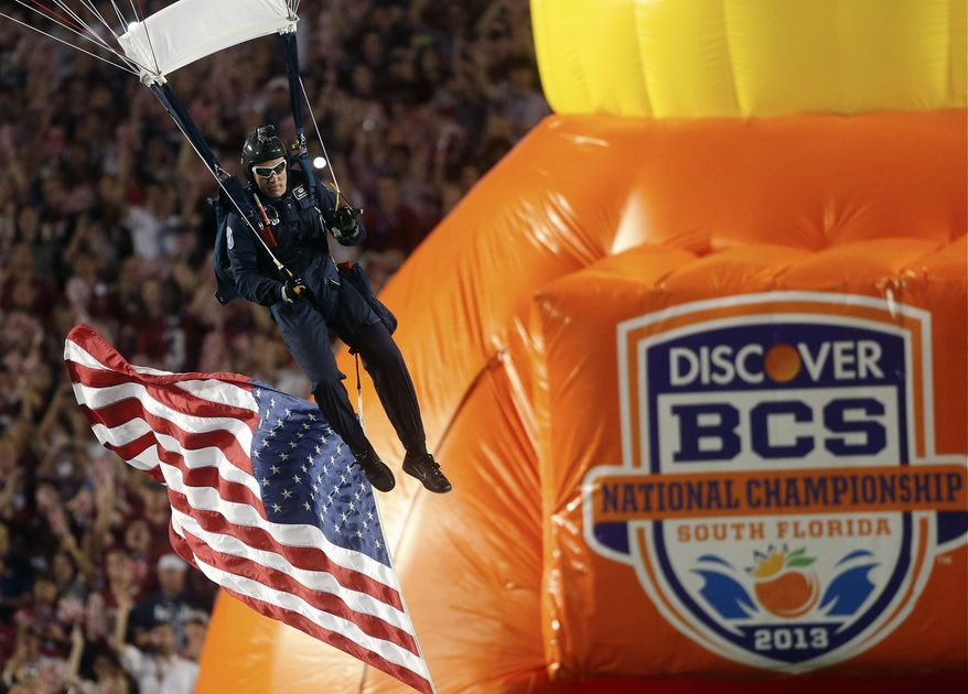 FILE - In this Jan. 7, 2013, file photo, a member of the U.S. Army jumps into the stadium before the first half of the BCS National Championship college football game between Alabama and Notre Dame in Miami. The conference commissioners in charge of putting together the four-team playoff system that will start after the 2014 regular season will meet starting Tuesday, April 23, 2013, in Pasadena, Calif. At the top of their agenda: Pick three more bowls to be used in the semifinal rotation and decide on a site for the first national championship game. (AP Photo/John Bazemore, File)